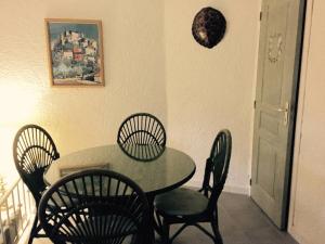 a dining room with a table and four chairs at San Ciprianu in Porto-Vecchio