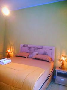Postel nebo postele na pokoji v ubytování Three V Homestay