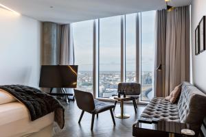 a hotel room with a bed and a large window at Tower Suites Reykjavík in Reykjavík