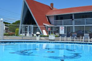 a swimming pool in front of a building at Cape Shore Inn in South Yarmouth