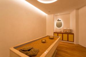 a room with a wooden floor and a large mirror at Vila Vita Parc Resort & Spa in Armação de Pêra
