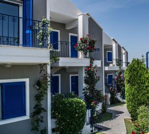 a row of apartment buildings with flowers on balconies at Limni Hotel in Fanari
