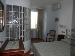 Postel nebo postele na pokoji v ubytování Albergo Lucia Pagnanelli