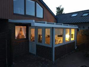 a screened in porch of a house with a patio at Haus Seeblick Ferienhaus Priwall in Priwall