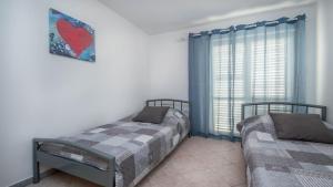 Postel nebo postele na pokoji v ubytování Apartment Medulin