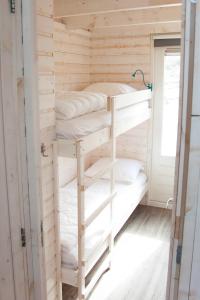 a bunk room with four bunk beds in it at Surf en beach strandhuisjes in Katwijk