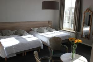 Postel nebo postele na pokoji v ubytování Hotel Lodewijk Van Male