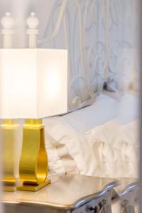 a bed with two lamps on a table next to a bed at Luxury London Apartment in London