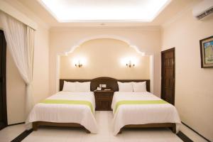 Postel nebo postele na pokoji v ubytování Hotel Caribe Merida Yucatan