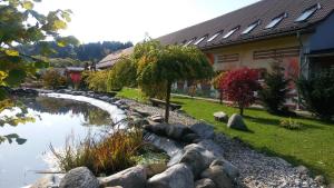 a stream in a yard next to a building at Penzion Sidorovo in Ružomberok