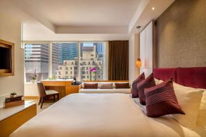 a bedroom with a large bed with a large window at Concorde Hotel New York in New York