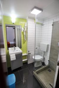 a bathroom with a toilet a sink and a shower at Anjo Azul in Lisbon