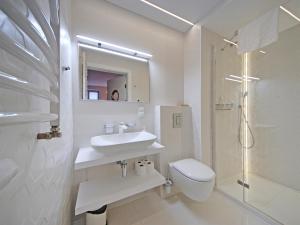 a bathroom with a sink and a toilet and a shower at Old Town by Apartmore in Gdańsk