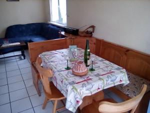 a table with a bottle of wine on top of it at Les gîtes du lindenberg in Dambach +4 photos