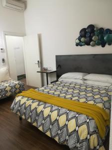 a bedroom with a bed with a yellow blanket on it at Brigid b&b in Florence