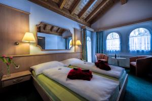 Postel nebo postele na pokoji v ubytování Wellness- und Schneesporthotel Christiania