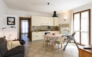 a kitchen and a living room with a table and chairs at Casina PiP in Colle Val D'Elsa