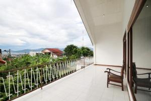 a balcony with a view of the mountains at Rarem Bed & Breakfast in Bandar Lampung