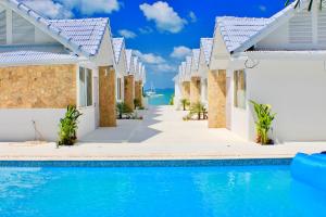 a villa with a swimming pool and a resort at So KohKoon Beach Resort in Bang Rak Beach