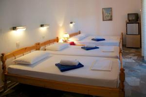 a group of four beds in a room at El Capitan in Porto Koufo