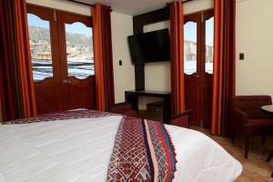 Postel nebo postele na pokoji v ubytování Altipacha Ayacucho Hotel