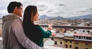 a man and a woman looking out over a city at Gran Hotel Guisama in Cajamarca
