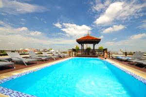 a swimming pool with chairs and a gazebo on a building at Khaosan Palace Hotel - SHA Extra Plus in Bangkok