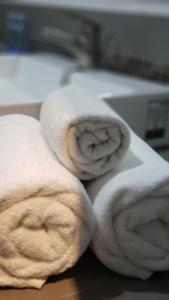 two rolls of white towels sitting on a table at Terrass Hotel Zamora in Zamora de Hidalgo