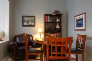 a room with a table and chairs and a book shelf at Sir Isaac Brock B&B Luxury Suites in Brockville