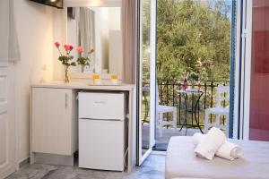 a kitchen with a small refrigerator and a balcony at Prince Studios in Sami