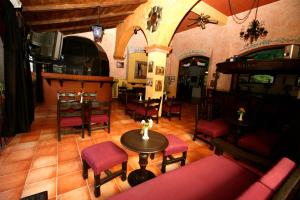 an overhead view of a living room with a table and chairs at Hotel Montetaxco in Taxco de Alarcón