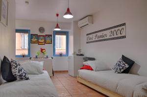 a living room with two beds and a kitchen at Studio Panier 2000 in Marseille