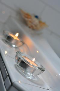 two candles sitting on top of a white table at Poachers Paradise in Rutherglen