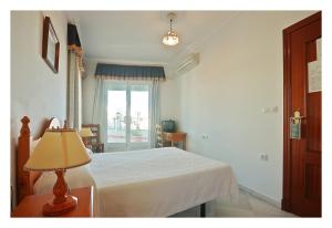 Postel nebo postele na pokoji v ubytování Hostal La Posada