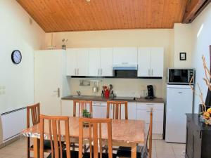 Una cocina con una mesa y algunos gabinetes blancos. en VILLA PRIVEE A 300M DE LA PLAGE, en Saint Gilles Croix de vie 20 fotos más