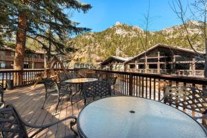 a patio with tables and chairs on a deck at Nicky's Resort in Estes Park