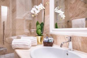 a bathroom with a sink and a mirror and a tub at Magville in Milan