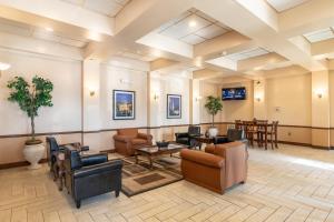 a lobby with couches and chairs and tables at Master Suites Hotel in Waldorf