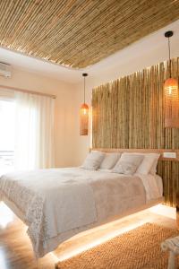 um quarto com uma cama grande e um tecto em madeira em Georgia Pelekanou Studios em Fira