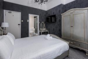 a bedroom with a bed and a dresser at Westbourne Hotel and Spa in Brighton & Hove