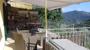 a balcony with chairs and a table with a view at Casa Ofelia in Levanto