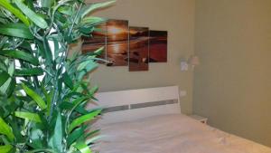 a bedroom with a bed and a potted plant at Casa Ofelia in Levanto