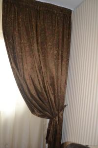 a curtain in a room next to a window at Relax Apartament in Constanţa