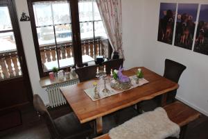 a dining room table and chairs with a table and a window at Ferienwohnung im Landhausstil in Missen-Wilhams