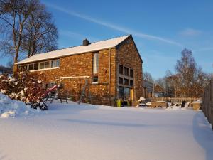 a brick building with snow in front of it at Gîte Le Rivage in Stavelot