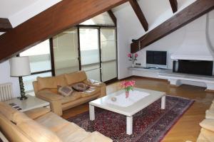 a living room with a couch and a coffee table at Hotel Ristorante Vapore in Faggeto Lario 