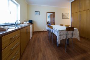 a kitchen with a table and a kitchen with a sink at Quinta do Oeste in Doze Ribeiras