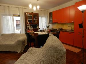 a kitchen with red cabinets and a table with chairs at B&B Joe in Valguarnera Caropepe