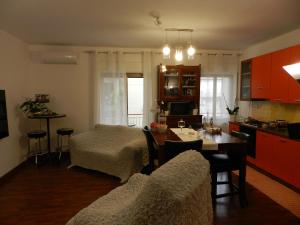 a kitchen and living room with a table and chairs at B&B Joe in Valguarnera Caropepe