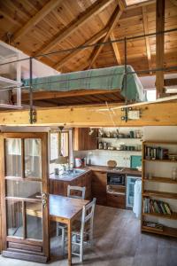 a kitchen with a table and a loft bed at Piges in Milína